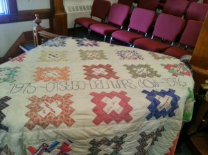 Quilt with squares naming famous historical feminists
